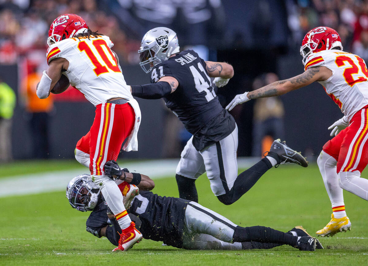 Kansas City Chiefs running back Isiah Pacheco (10) is stopped on a run by Raiders cornerback Na ...