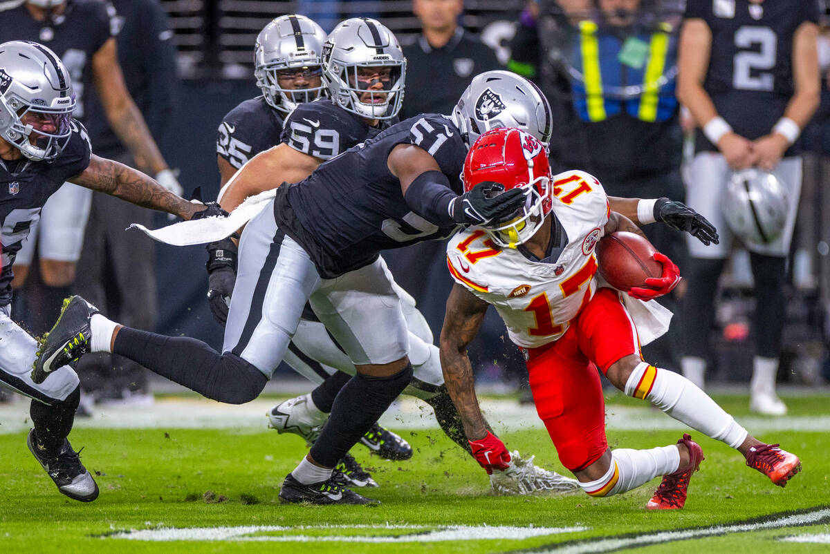 Kansas City Chiefs wide receiver Richie James (17) is grabbed by Raiders defensive end Malcolm ...