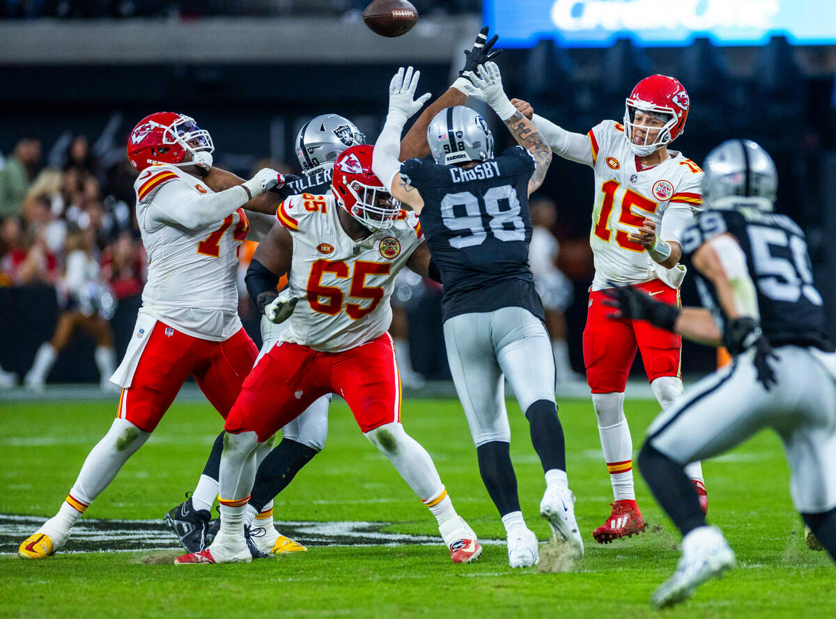 Raiders defensive end Maxx Crosby (98) reaches to block a pass by Kansas City Chiefs quarterbac ...