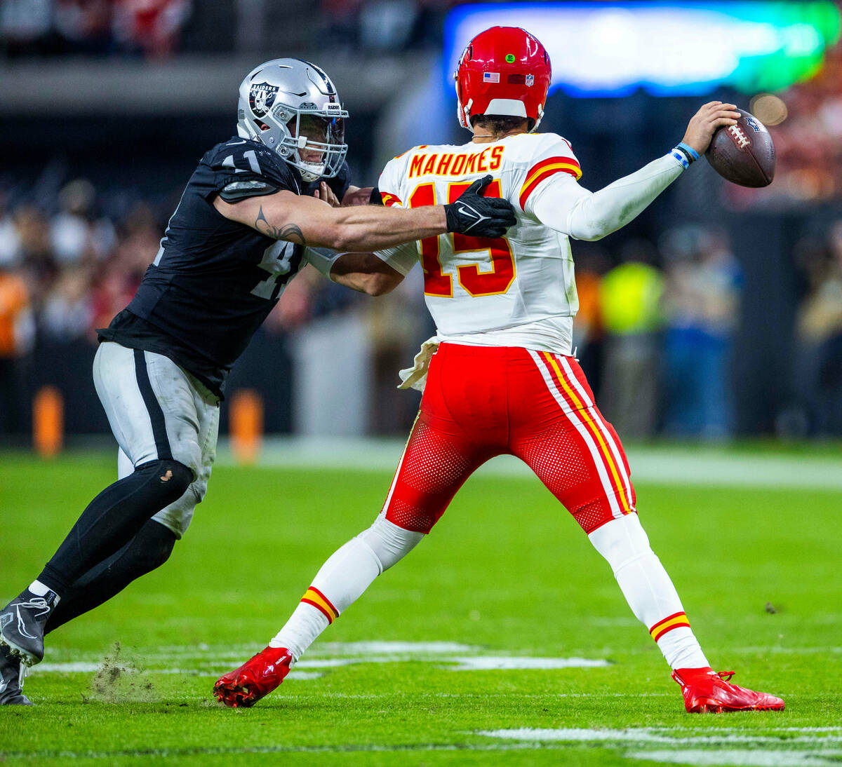 Raiders linebacker Robert Spillane (41) grabs Kansas City Chiefs quarterback Patrick Mahomes (1 ...