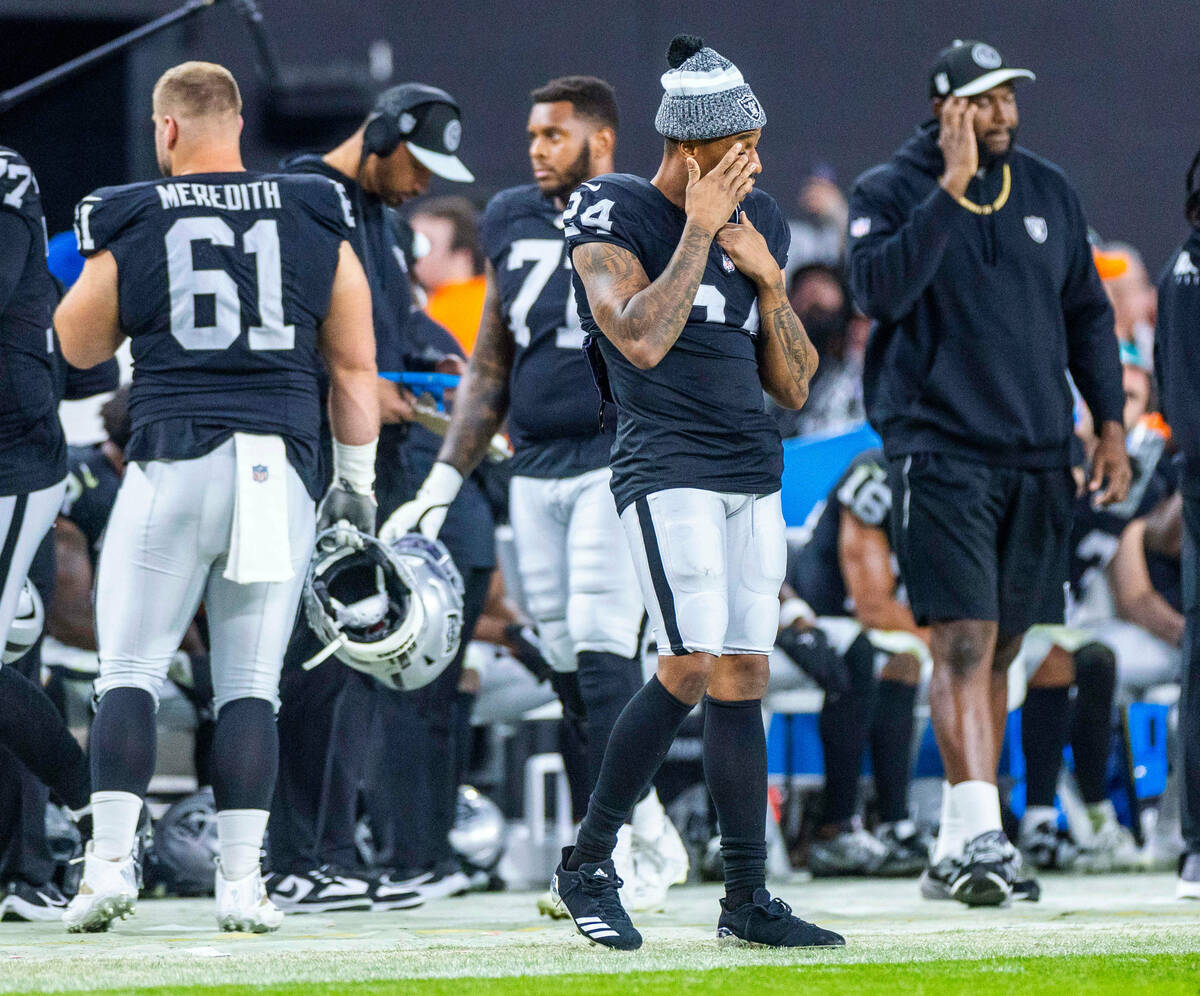 Raiders cornerback Marcus Peters (24) wipes his eye on the sidelines as the game winds down aga ...