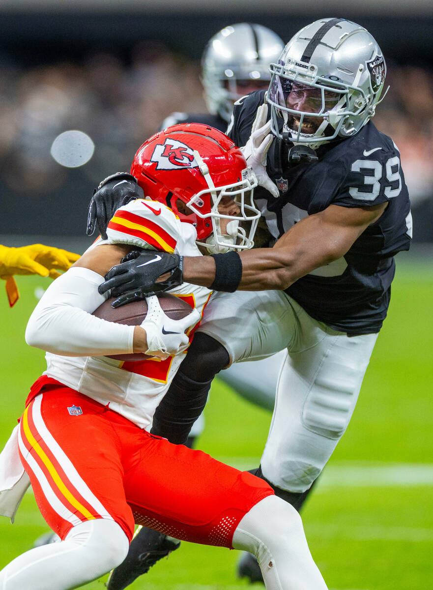 Kansas City Chiefs wide receiver Skyy Moore (24) is tackled by Raiders cornerback Nate Hobbs (3 ...
