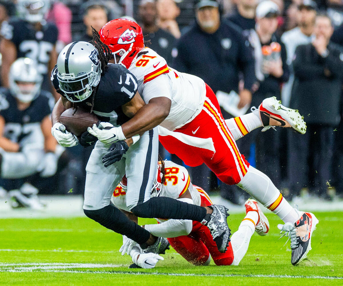 Raiders wide receiver Davante Adams (17) attempts top hold onto a reception as Kansas City Chie ...