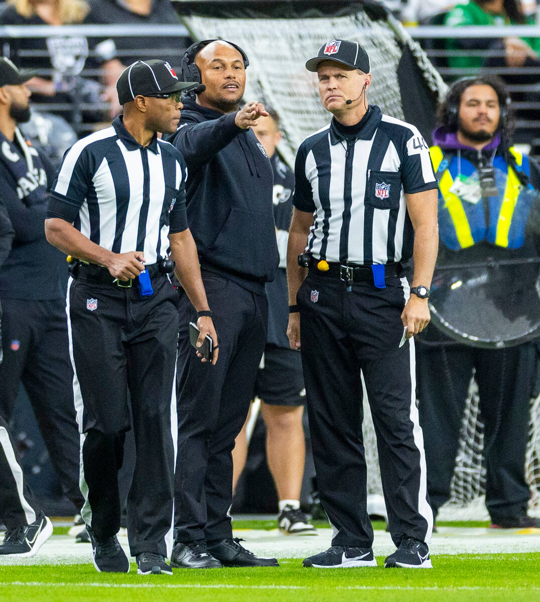Raiders interim head coach Antonio Pierce argues a ball spot with officials against the Kansas ...