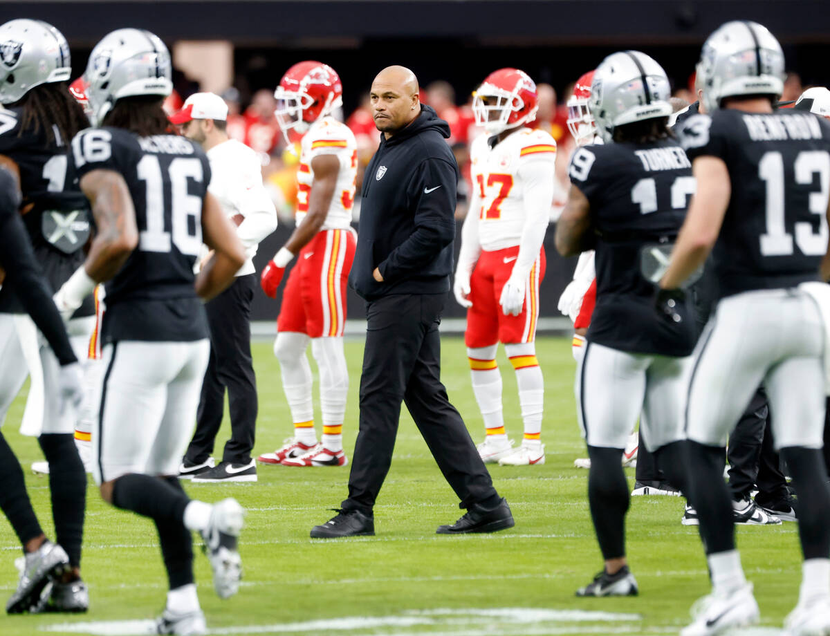 Raiders Interim Coach Antonio Pierce watches his players as they warm up to face Kansas City Ch ...