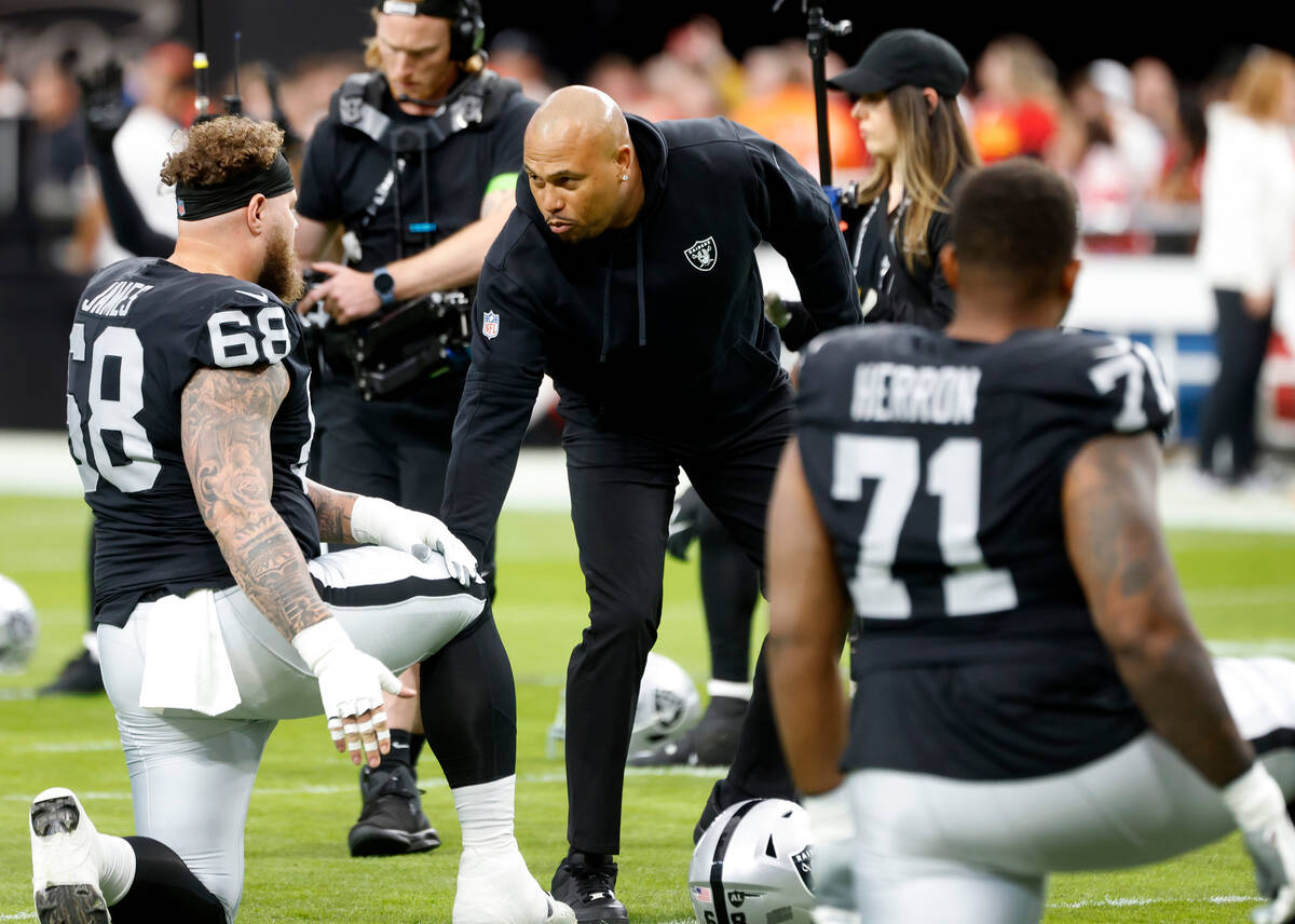 Raiders center Andre James (68) is greeted by Raiders Interim Coach Antonio Pierce as he stretc ...