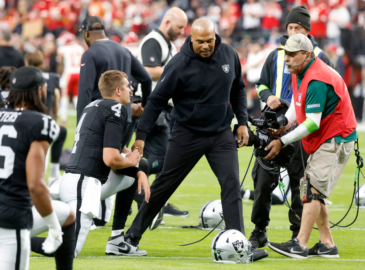 Raiders quarterback Aidan O'Connell (4) shakes hands with Interim Coach Antonio Pierce as he st ...