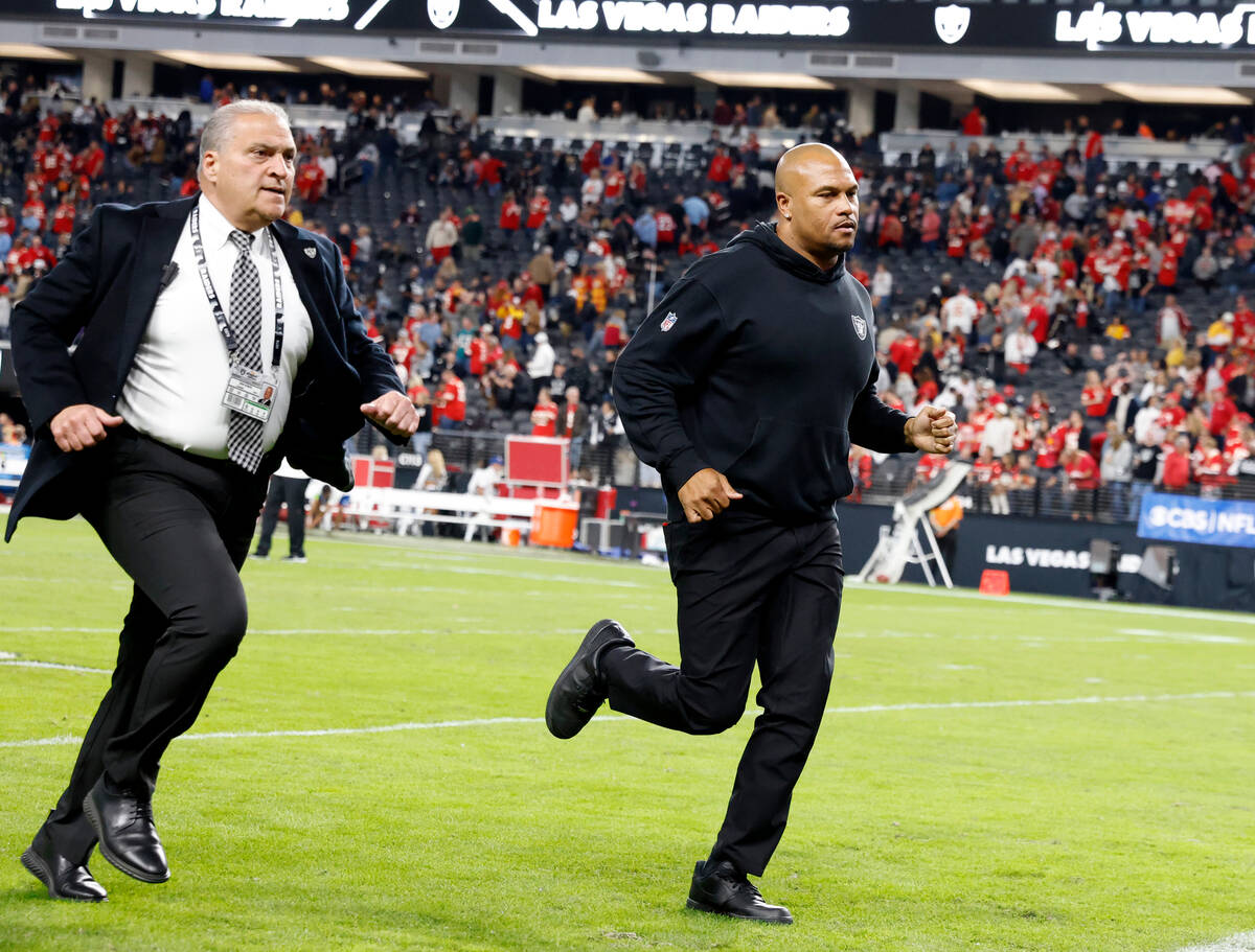 Raiders Interim Coach Antonio Pierce, right, leaves the field after losing 31-17 to Kansas City ...