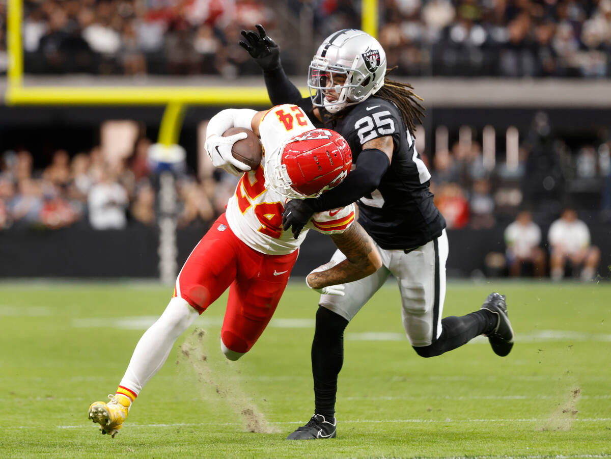 Raiders safety Tre'von Moehrig (25) tries to take down Kansas City Chiefs wide receiver Skyy Mo ...