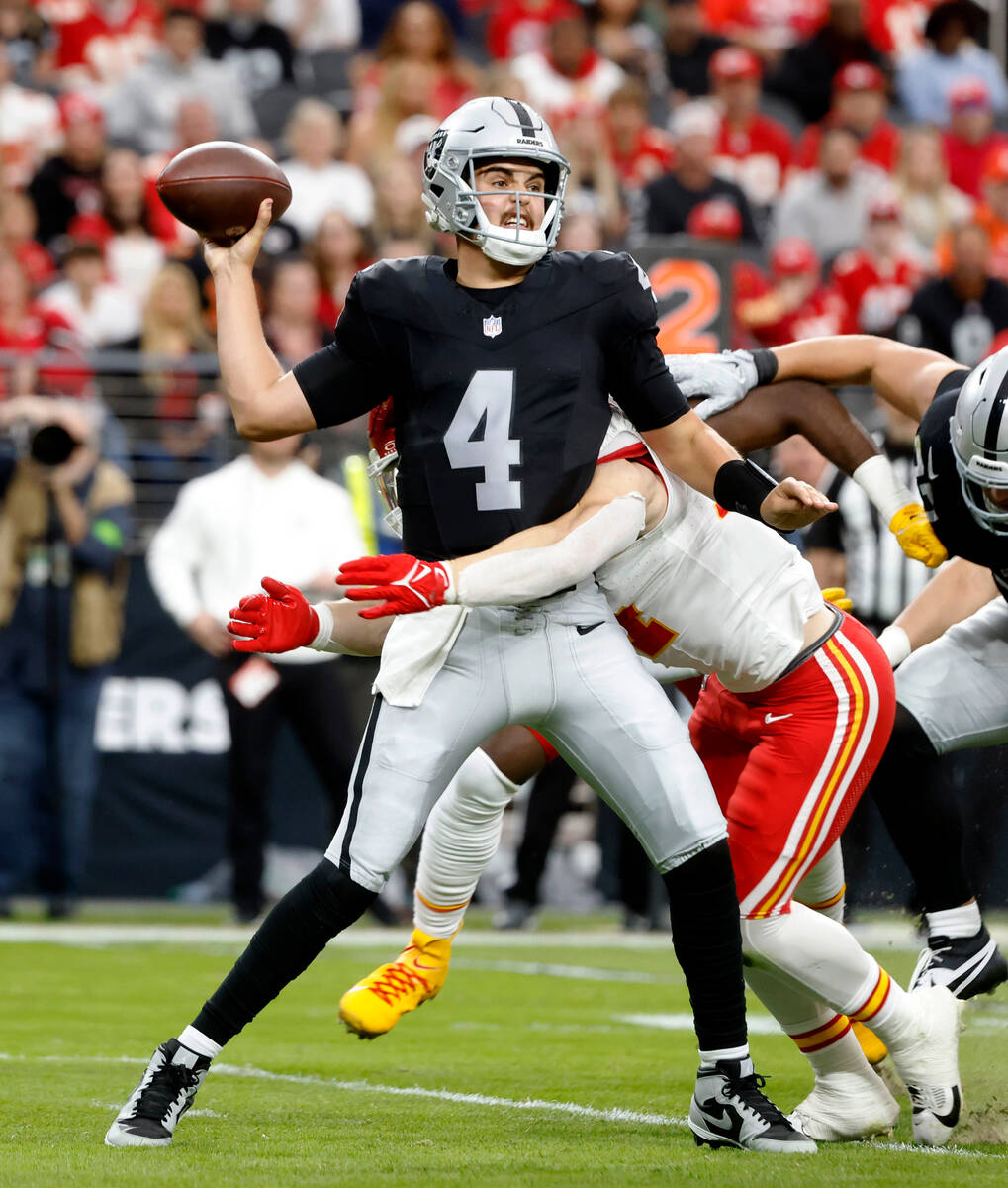 Raiders quarterback Aidan O'Connell (4) is tackled by Kansas City Chiefs linebacker Leo Chenal ...