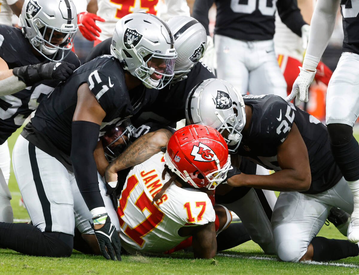 Kansas City Chiefs wide receiver Richie James (17) is taken down by Raiders defense during the ...
