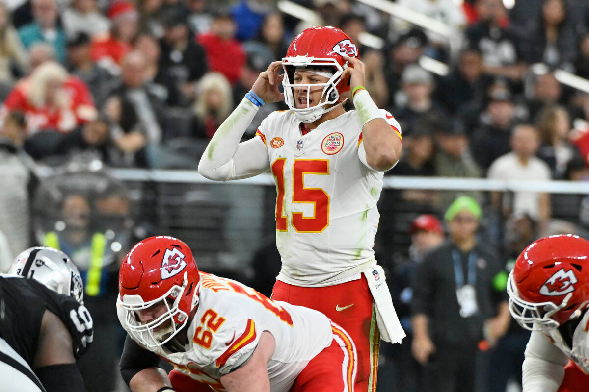 Kansas City Chiefs quarterback Patrick Mahomes (15) signals at the line of scrimmage during the ...