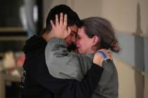 This handout photo provided by Haim Zach/GPO shows Sharon Hertzman, right, hugging a relative a ...