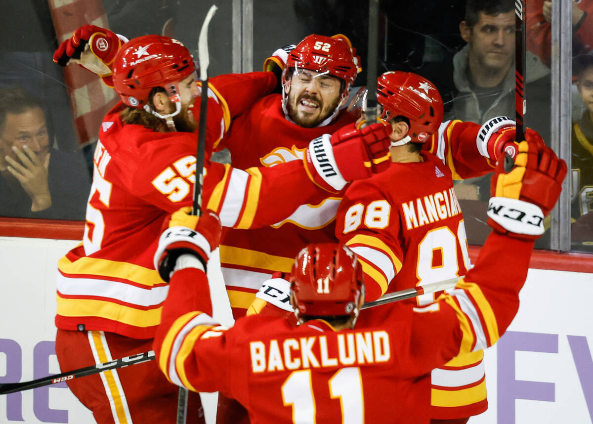 Calgary Flames defenseman MacKenzie Weegar, center, celebrates his goal with teammates in overt ...