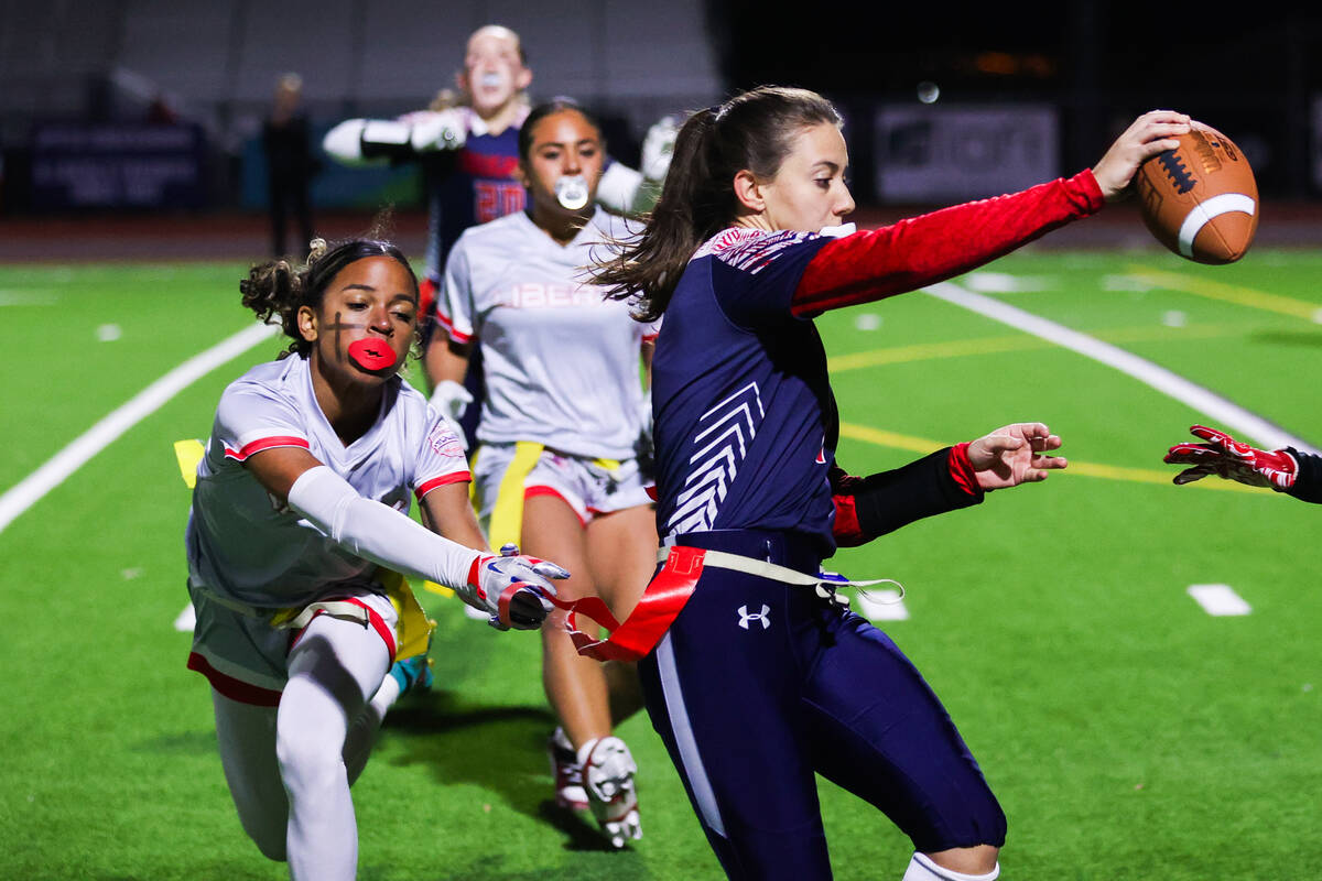 A Liberty player pulls the flag off of Maci Joncich (1) during a flag football game between Cor ...