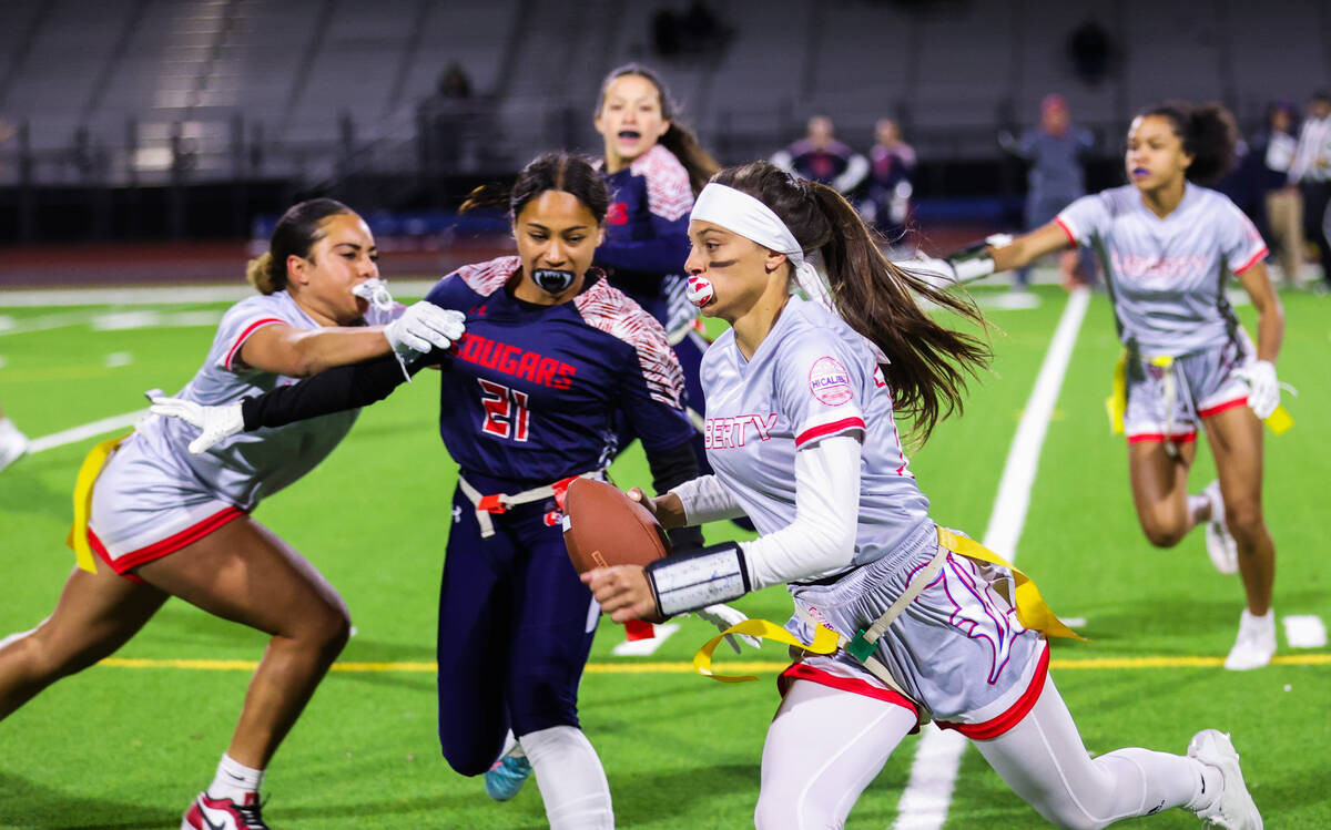 Liberty’s Kaylie Phillips (14) runs the ball down the field during a flag football game ...