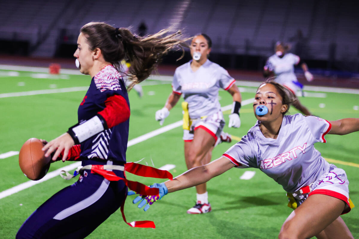 A Liberty player reaches to the pull the flag off of Coronado’s Maci Joncich (1) during ...
