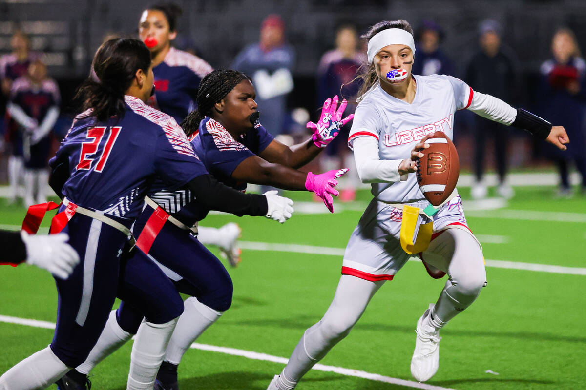 Liberty’s Kaylie Phillips (14) runs the ball down the field during a flag football game ...