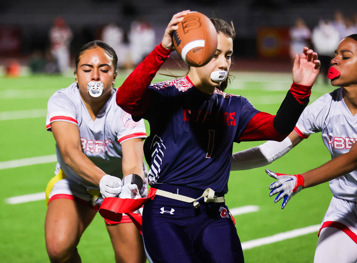 Liberty’s Lolo Westerlund (4) pulls the flag off of Coronado’s Maci Joncich (1) d ...