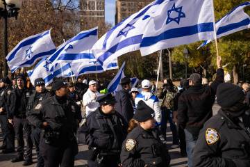 Police officers keep pro-Israel protesters away from people gathered for a demonstration in sup ...