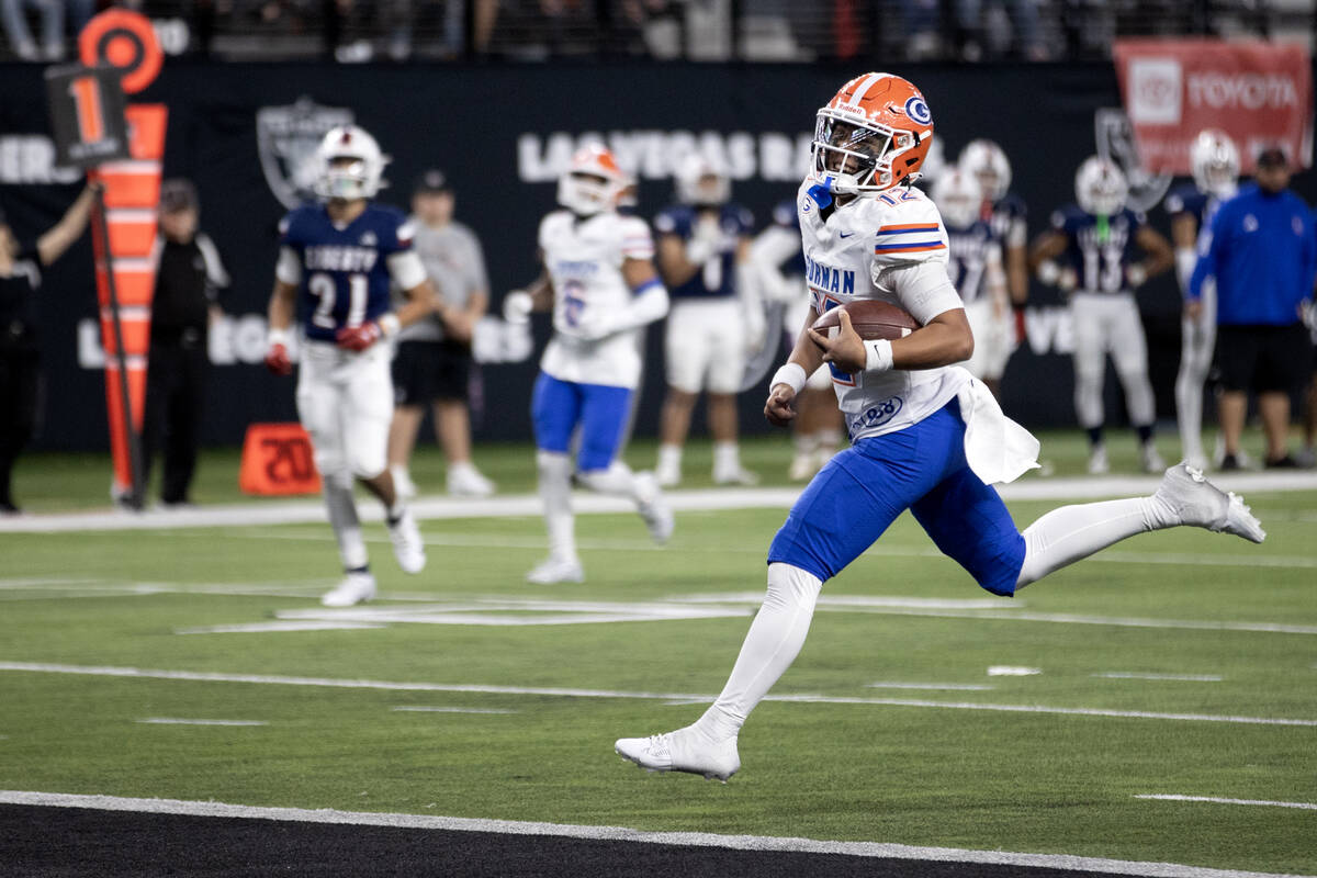 Bishop Gorman senior captain and quarterback Micah Alejado leaps into the end zone for a touchd ...