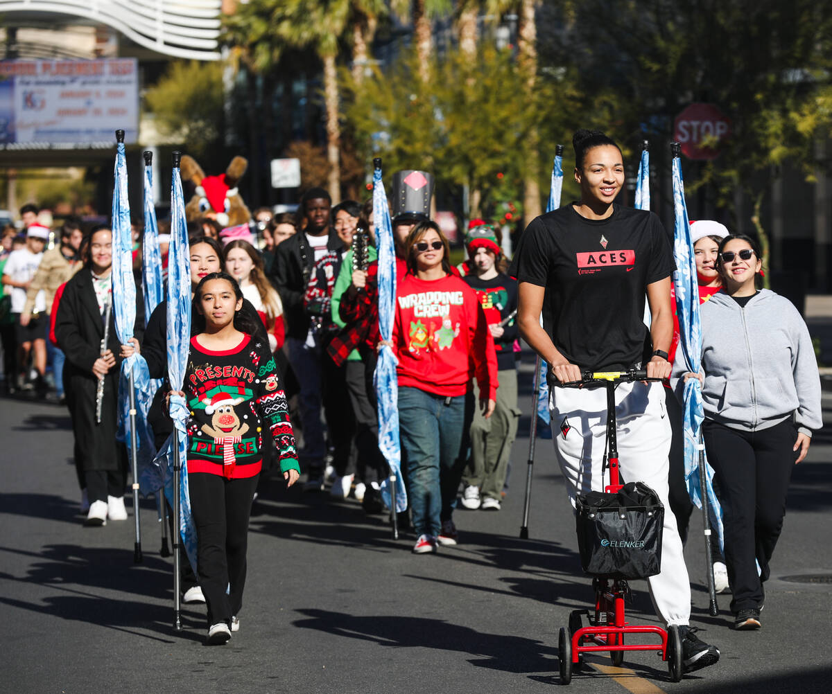 Las Vegas Aces player Kiah Stokes leads a parade of the Palo Verde High School Marching Band to ...
