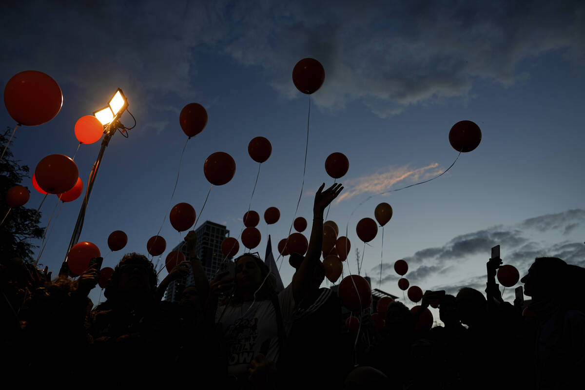Protesters release balloons as they call for the release of the Bibas family, whose members are ...
