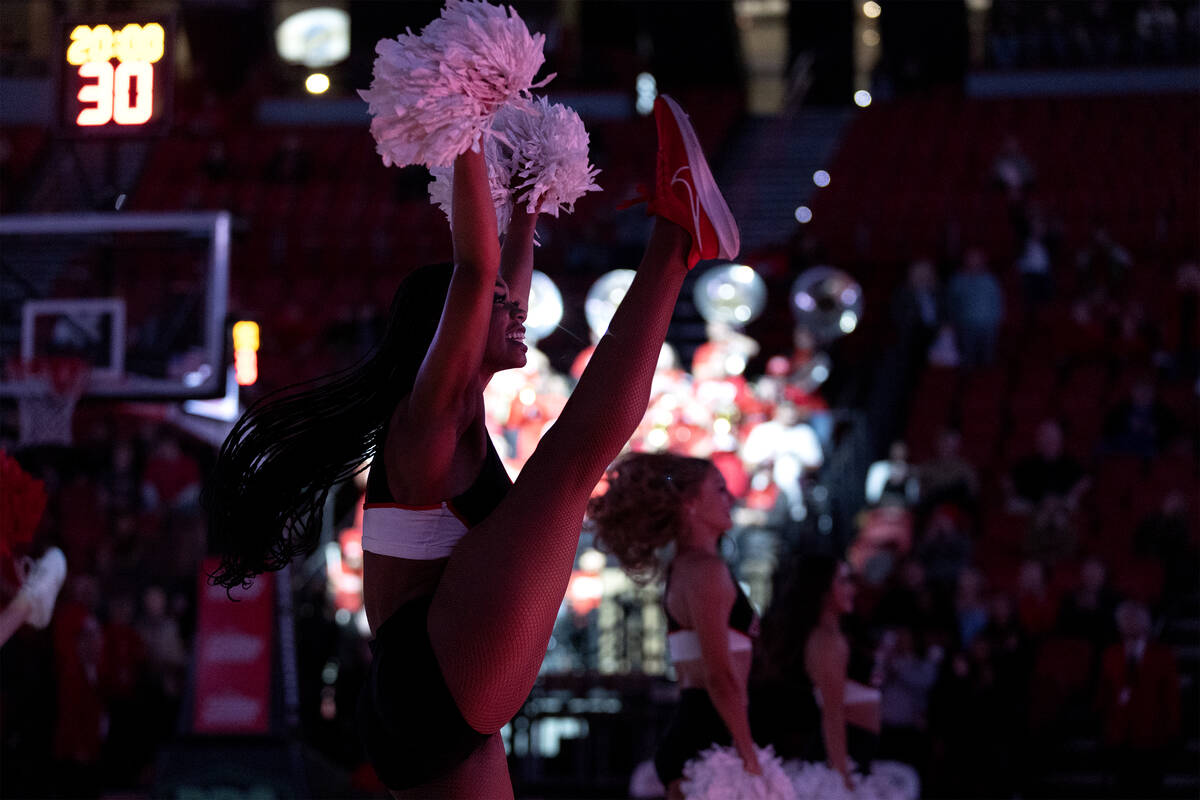 The UNLV Rebel Girls & Company kick off an NCAA college basketball game between the UNLV Re ...