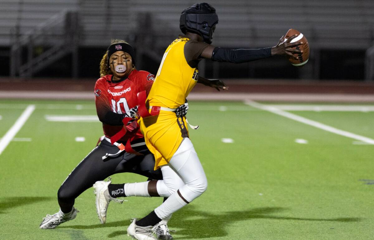 Desert Oasis linebacker Brooklin Hill (10) grabs the flag of Bonanza’s Nyanoang Gatchang (11) ...