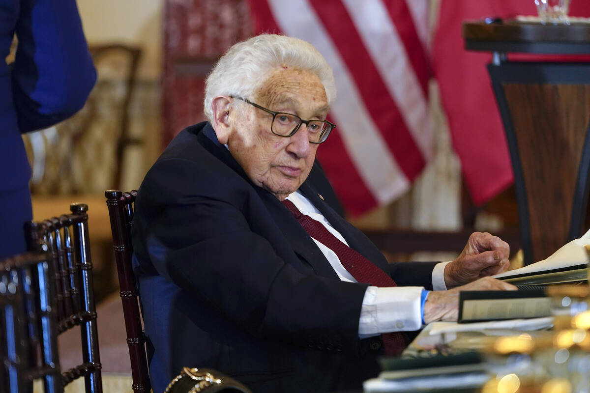 FILE - Former U.S. Secretary of State Henry Kissinger attends a luncheon with French President ...