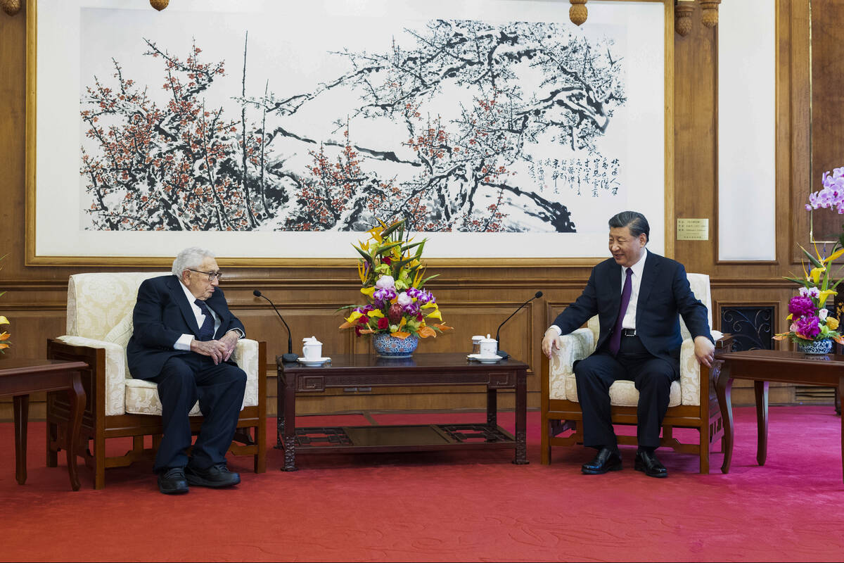 In this photo released by Xinhua News Agency, Chinese President Xi Jinping, right, talks to for ...