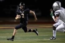 Faith Lutheran quarterback Garyt Odom (3) runs with his kept ball during the first half of a hi ...