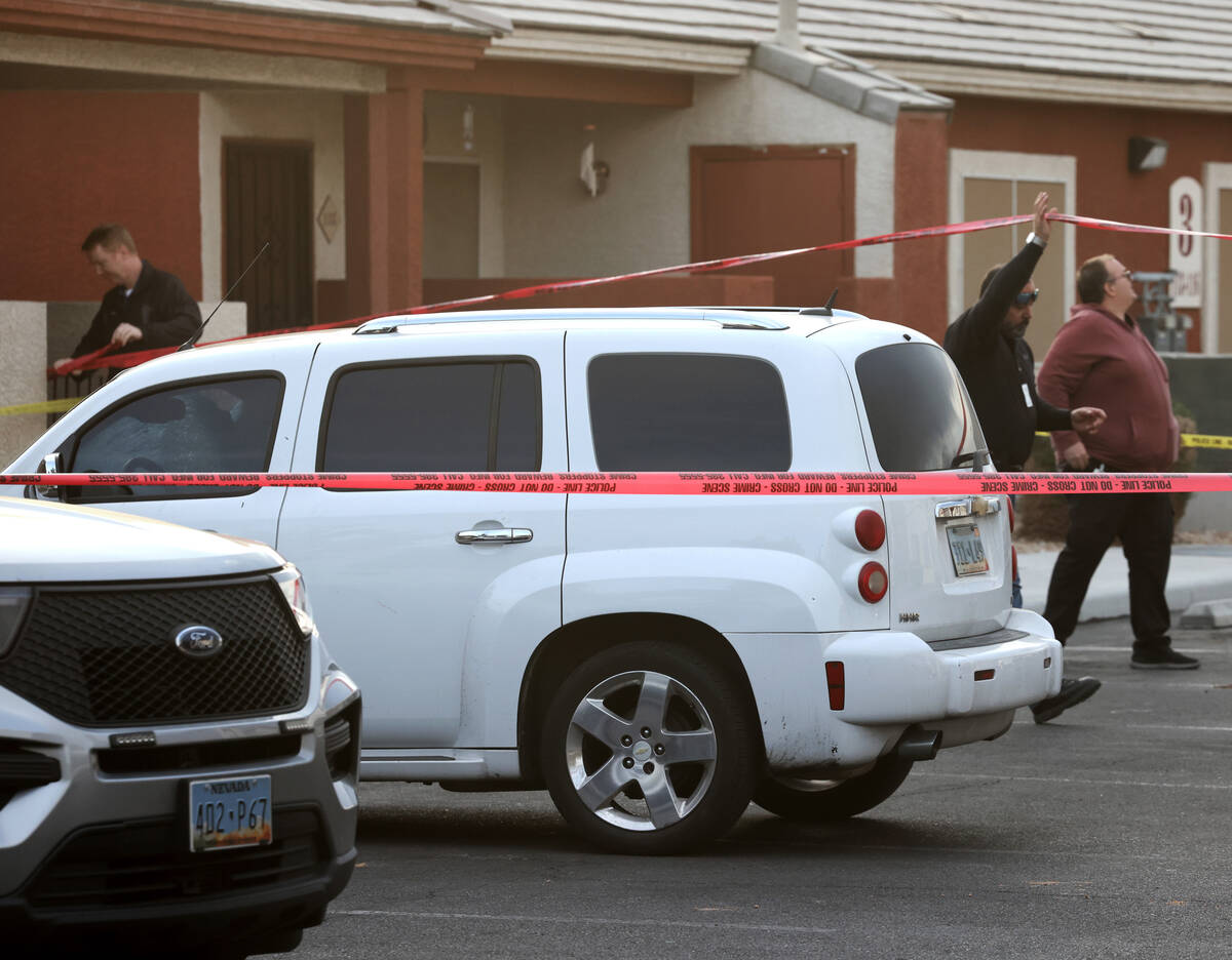 Las Vegas police investigate a white Chevrolet HHR in a housing complex on Monroe Avenue near I ...
