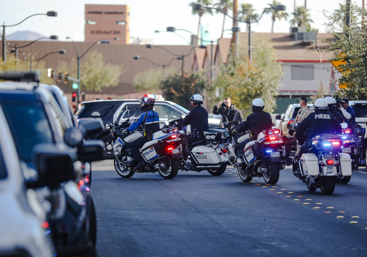 A police procession for a slain Nevada Highway Patrol Trooper moves towards the coroner’ ...