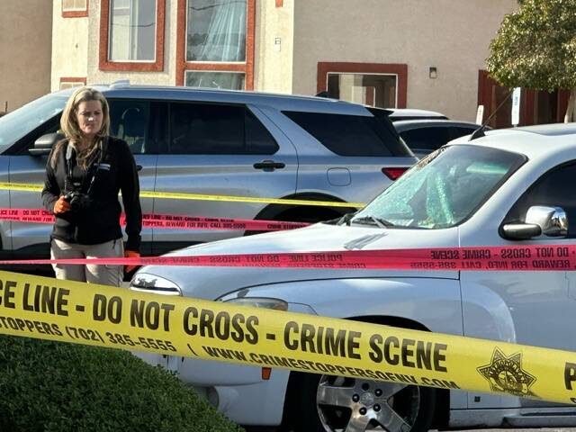 Investigators are seen at an apartment complex near J Street and Monroe Avenue, where police ta ...