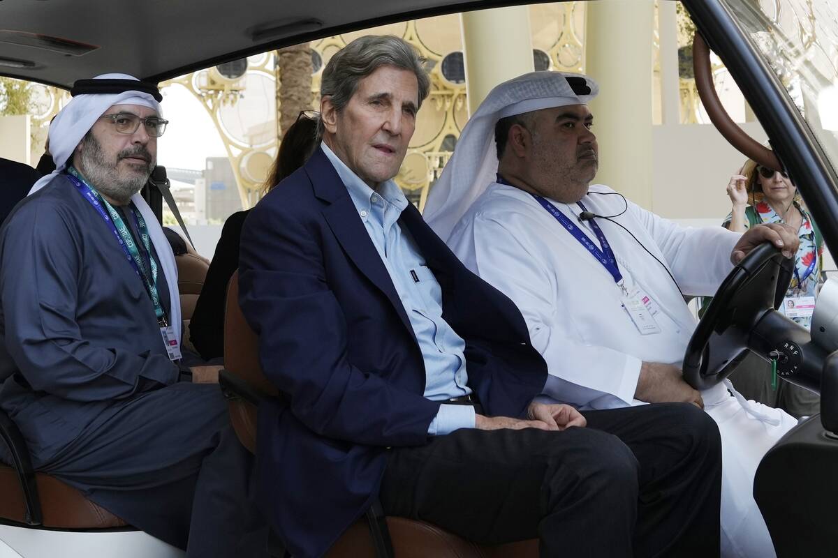 John Kerry, U.S. Special Presidential Envoy for Climate, rides in a cart ahead of the COP28 U.N ...