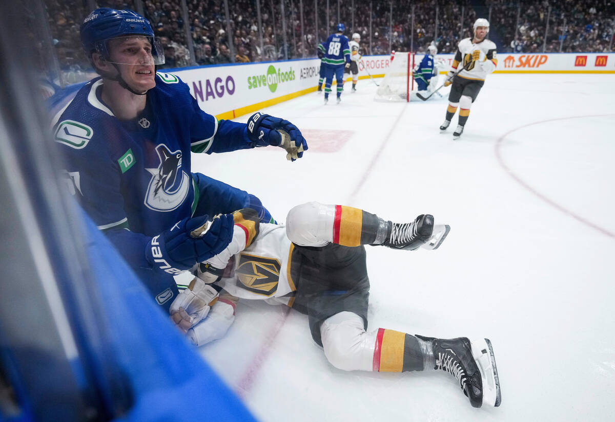 Vancouver Canucks' Tyler Myers, left, reacts to the referee after being penalized for checking ...