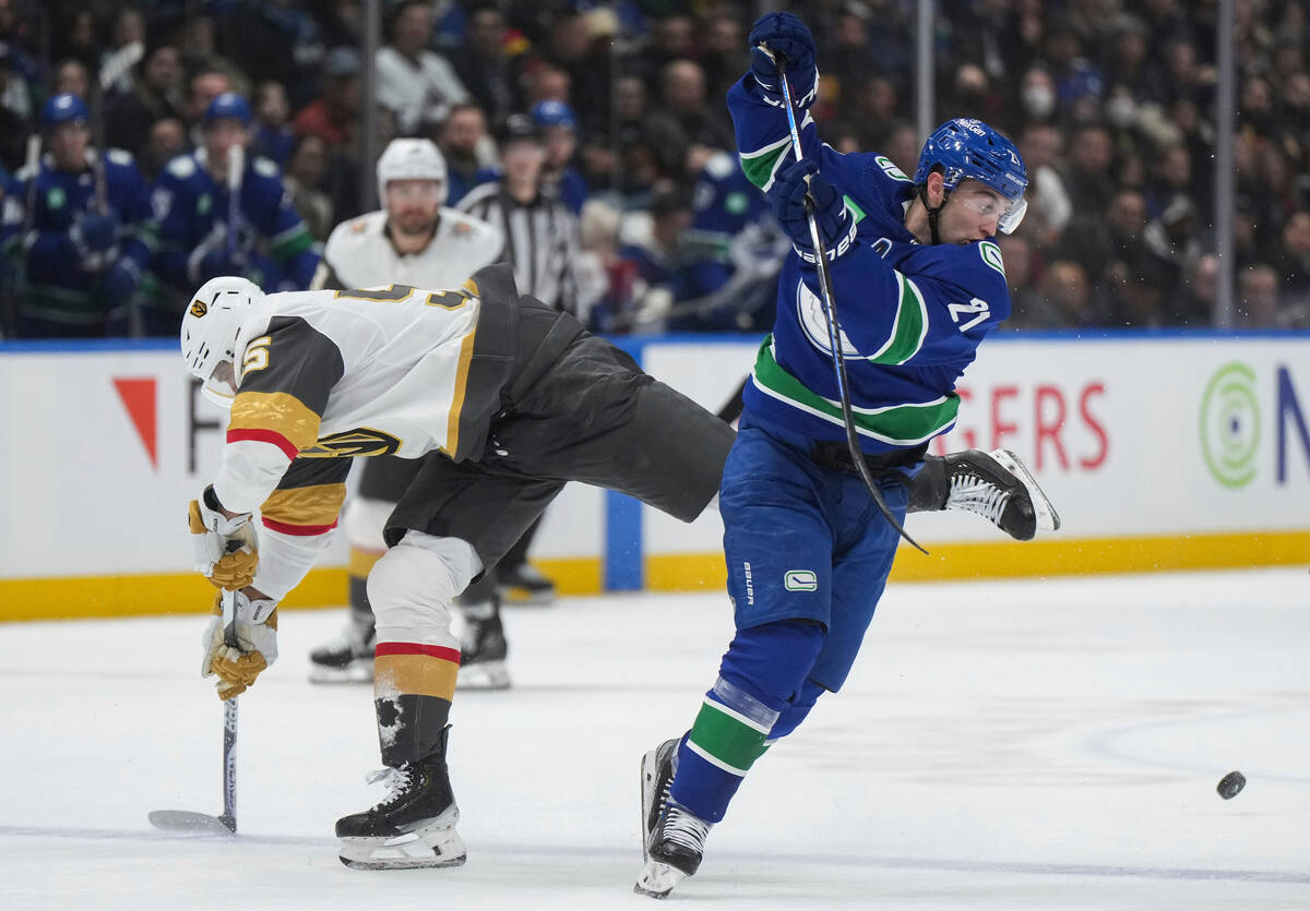 Vancouver Canucks' Nils Hoglander, right, avoids a collision with Vegas Golden Knights' Keegan ...