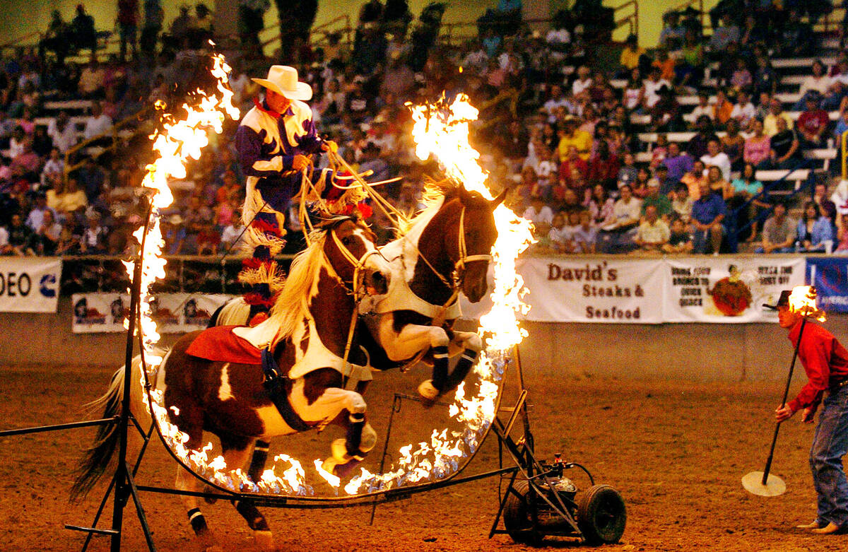 John Harrison of Soper, OK, with John Harrison Specialty Acts rides two through a ring of fire ...