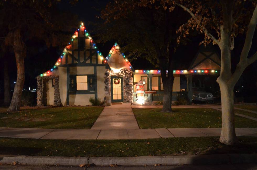 Holiday lights and decorations brighten the Goumond House, one of homes along Heritage Street, ...