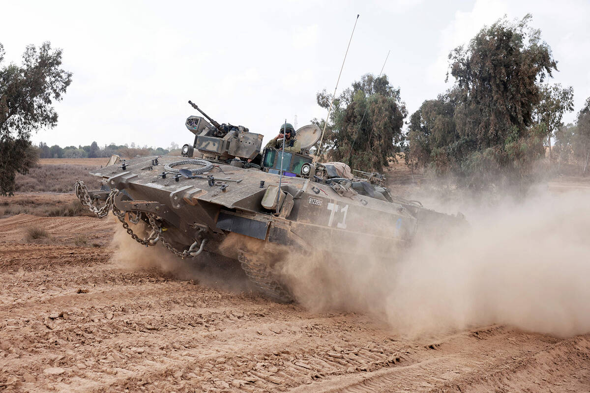 Israeli troops advance near the border with the Gaza Strip on Nov. 14, 2023, amid ongoing battl ...