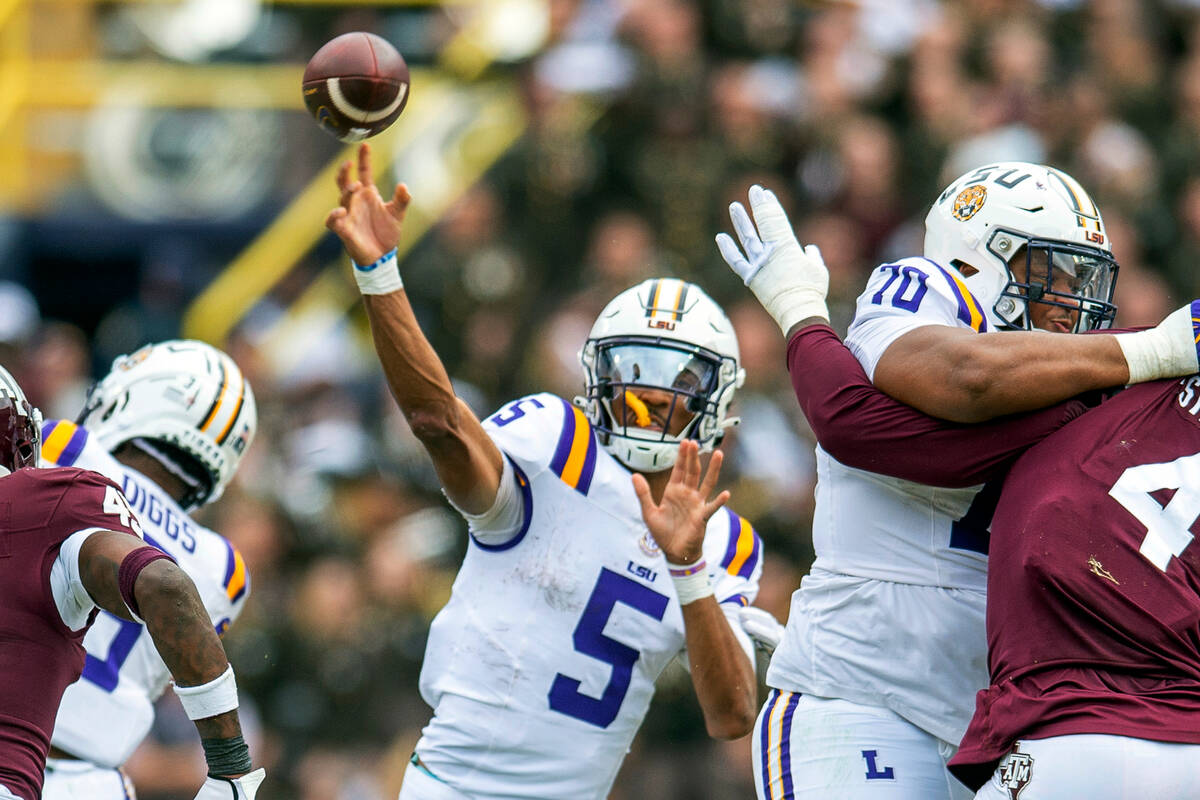 LSU quarterback Jayden Daniels (5) throws during an NCAA college football game against Texas A& ...