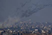 Rockets are fired toward Israel from the Gaza Strip, as seen from southern Israel, Friday, Dec. ...