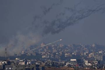 Rockets are fired toward Israel from the Gaza Strip, as seen from southern Israel, Friday, Dec. ...