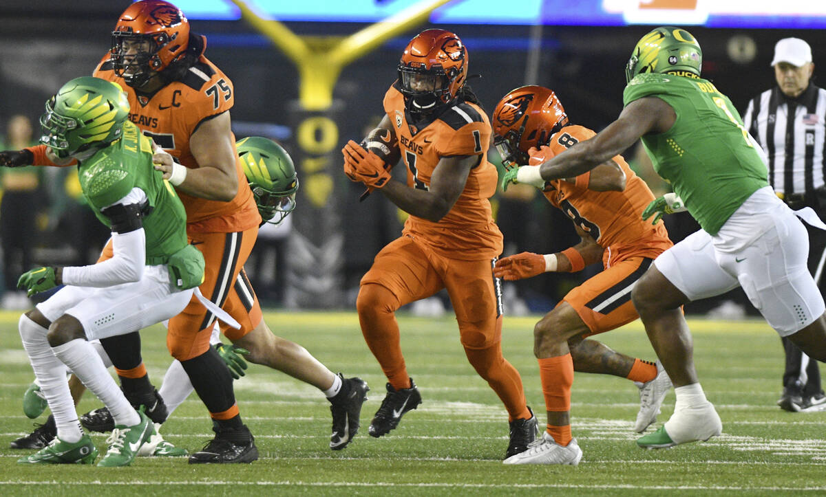 Oregon State running back Deshaun Fenwick rushes against Oregon during the first half of an NCA ...