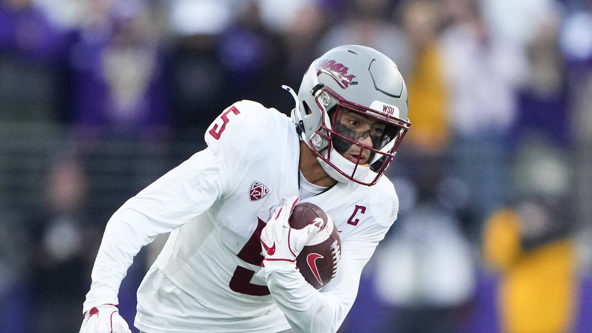 Washington State wide receiver Lincoln Victor (5) carries the ball against Washington during th ...