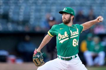 Oakland Athletics pitcher Ken Waldichuk throws against the Chicago Cubs during the first inning ...