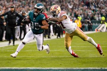 Philadelphia Eagles running back Boston Scott, left, runs for a touchdown past San Francisco 49 ...