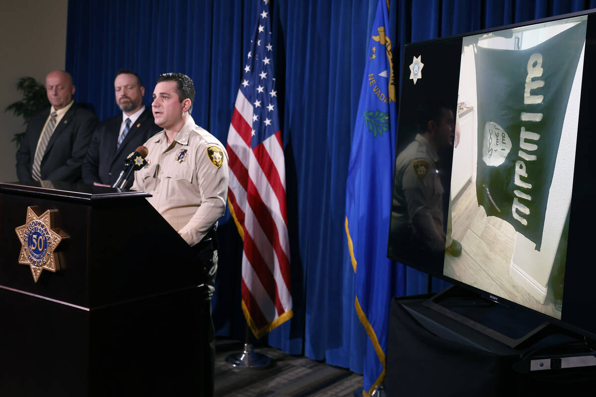 A handmade ISIS flag, right, made by a suspect is displayed as Deputy Chief Dori Koren, LVMPD c ...