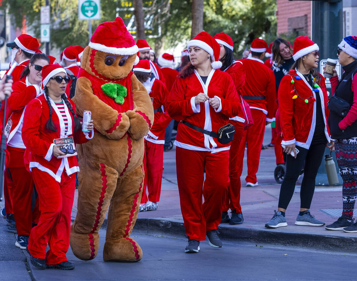 The Gingerbread Man and other participants walk to the starting line during the Las Vegas Great ...